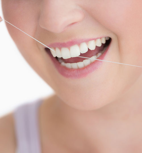 Woman flossing teeth
